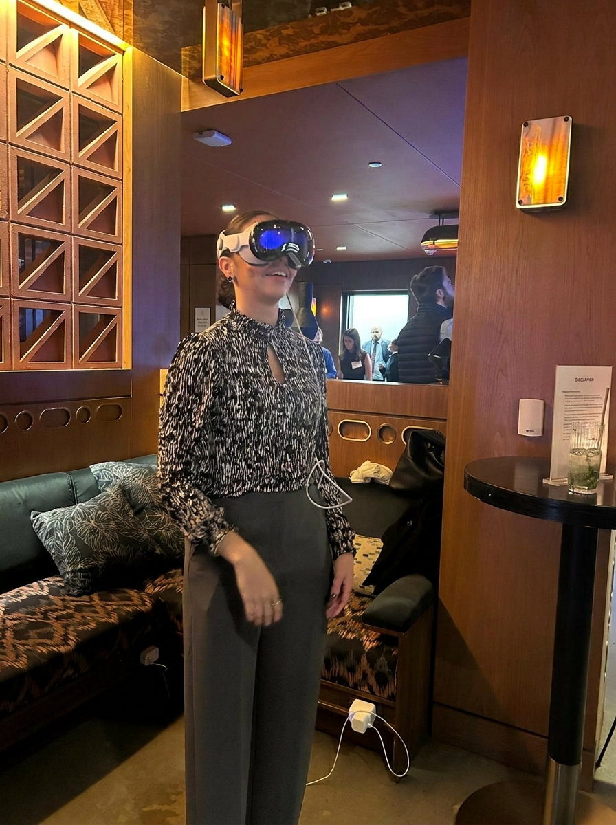 Business attendee wearing a VR headset and smiling during an immersive event experience